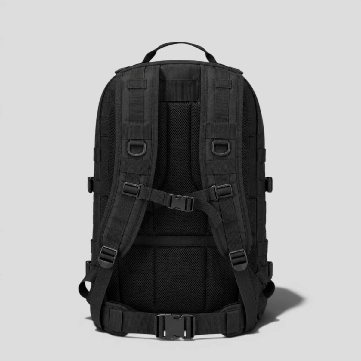 Back panel of black onyx military backpack showing padded shoulder straps, sternum strap, and hip buckle carry system
