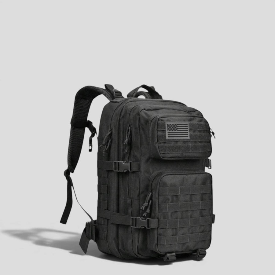 Side view of black tactical military backpack showing padded shoulder straps, MOLLE webbing, and structured upright body