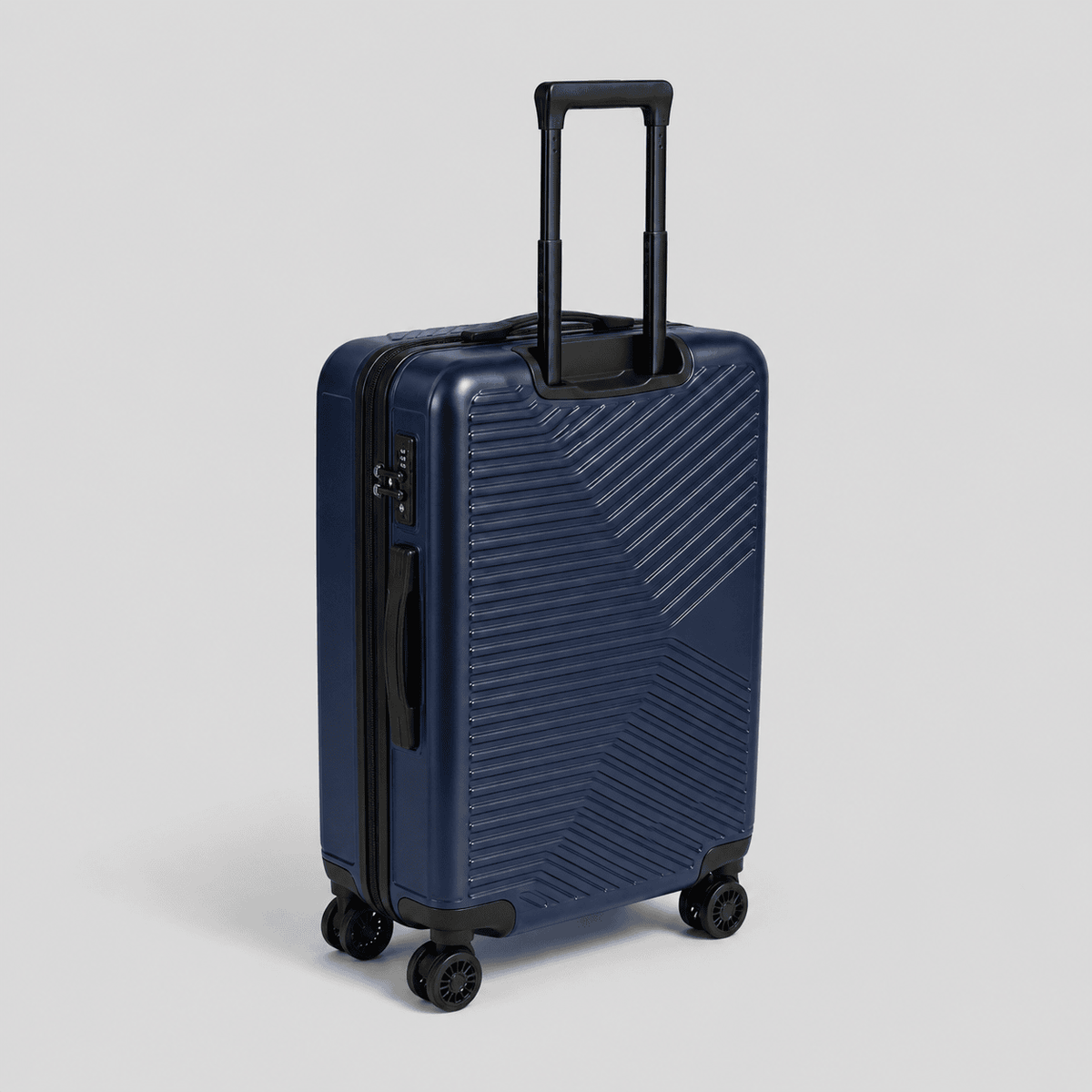 Navy blue hardshell carry on luggage with diagonal chevron ribbed exterior, black telescoping handle, TSA lock, and 360 spinner wheels
