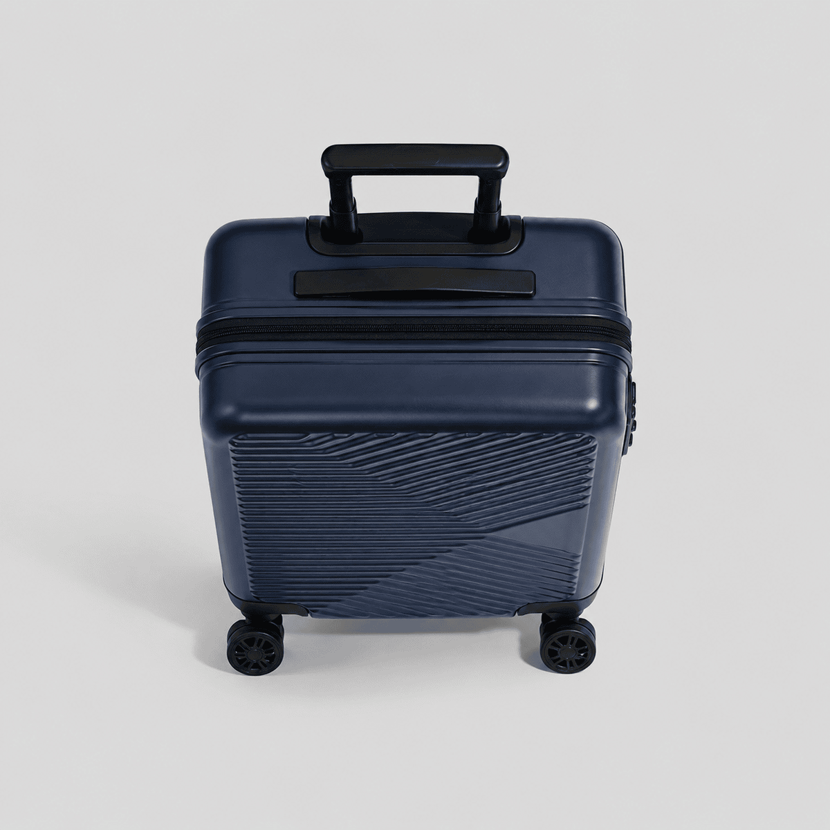 Top down view of navy blue large carry on suitcase showing full chevron rib pattern, perimeter zipper, and dual spinner wheels
