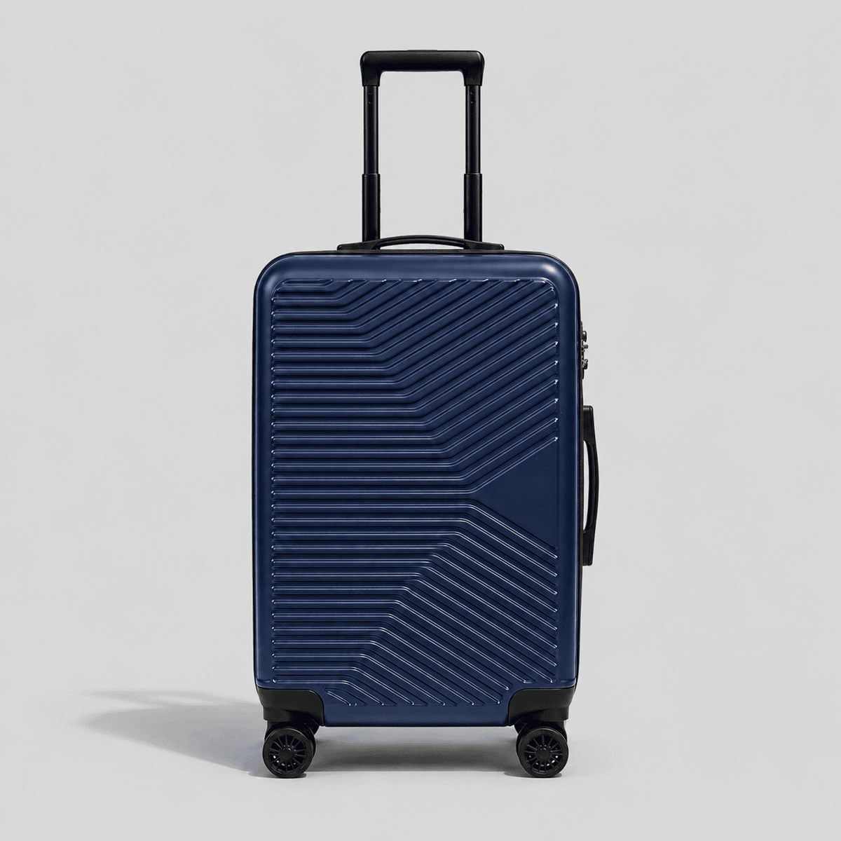 Navy blue hardshell carry on luggage with diagonal chevron ribbed exterior, black telescoping handle, TSA lock, and 360 spinner wheels

