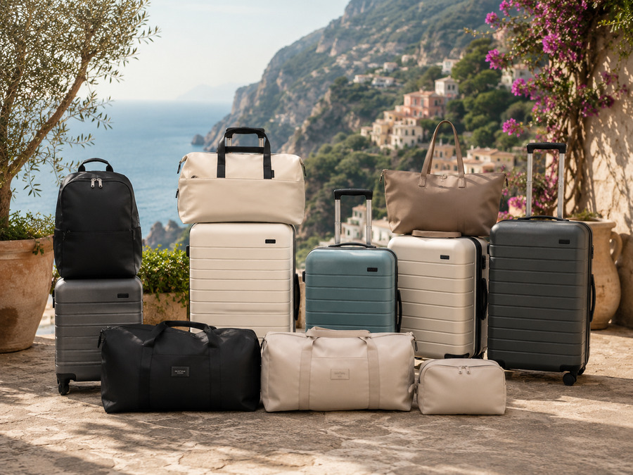 Collection of roamio suitcases and bags on a scenic background with mountains and ocean.