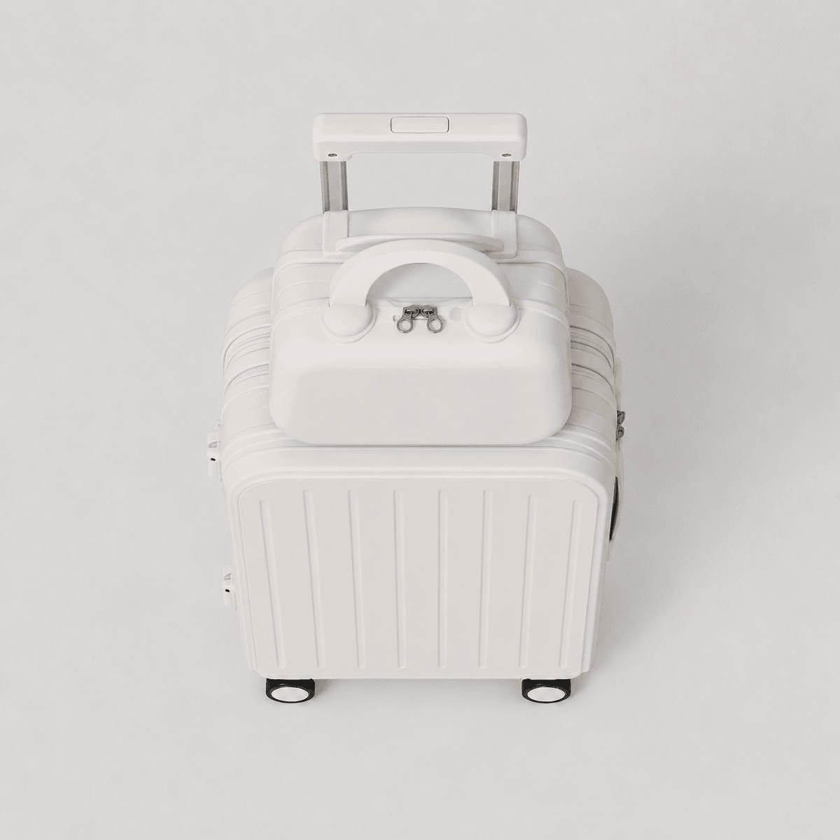 Top down view of cream white travel suitcase showing vertical ribbed shell, mounted cup holder, side charger port, and perimeter zipper
