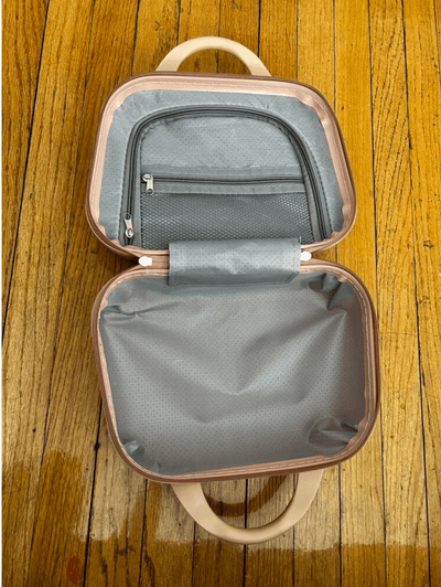 Small gray roamio atlas designer bag with beige handles on a wooden floor
