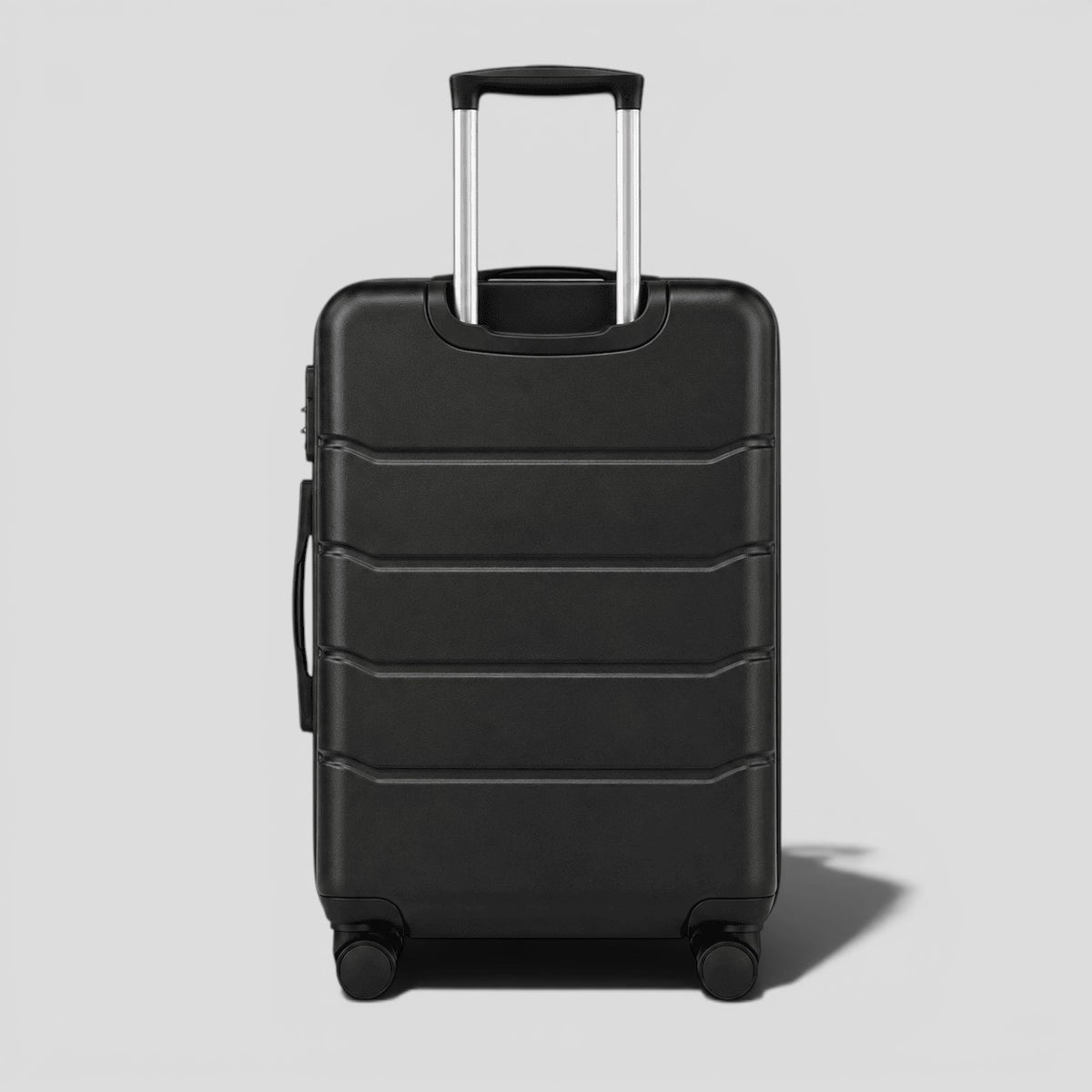 Black onyx hardshell large suitcase with horizontal ribbed exterior, extended telescoping handle, and four 360 degree spinner wheels
