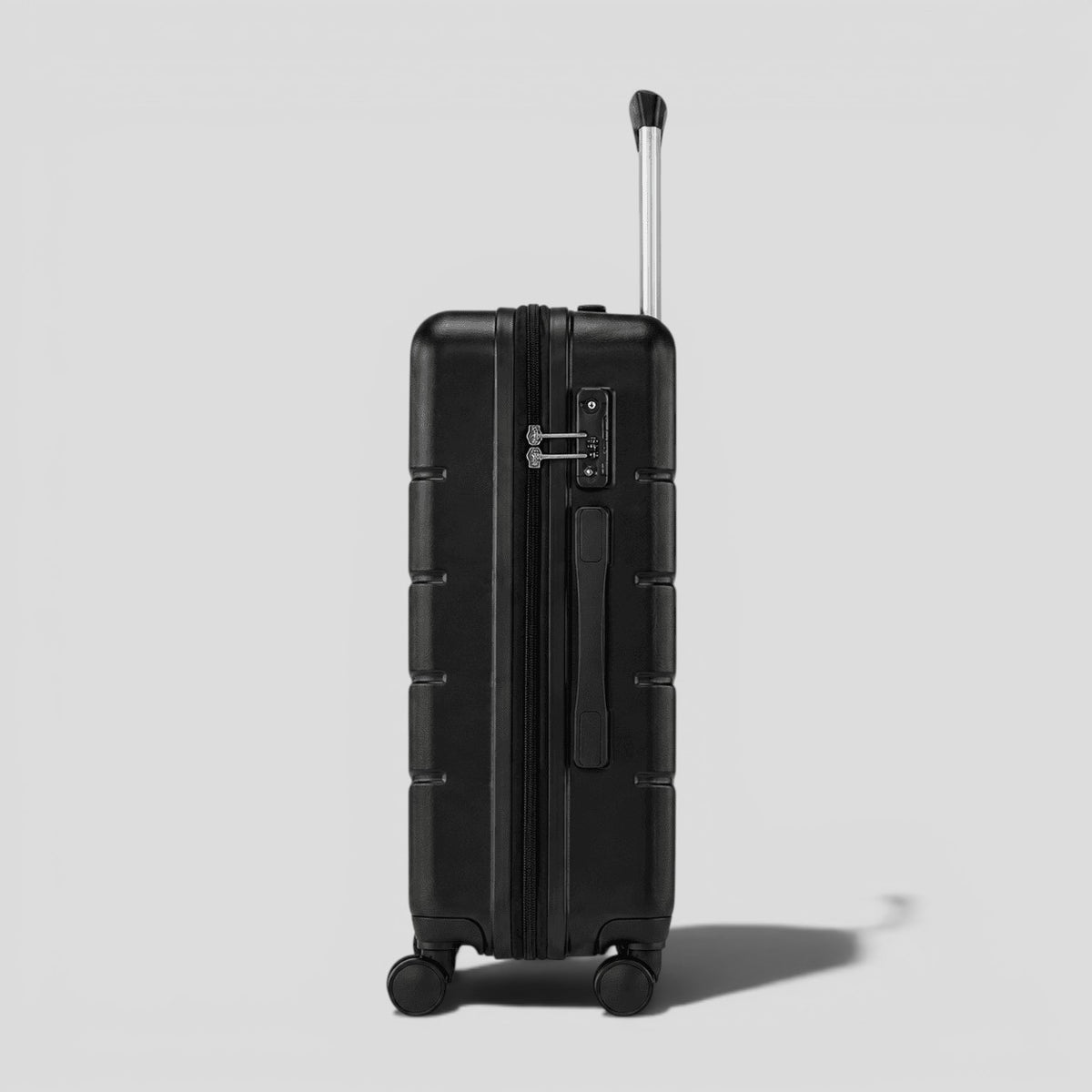 Side view of black matte hardshell carry on luggage showing perimeter zipper, side carry handle, and spinner wheel base
