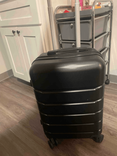Black Roamio Core on a wooden floor with a cart in the background
