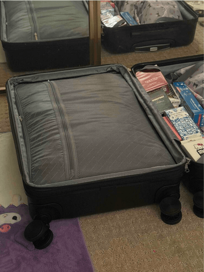 Black Roamio Core on a carpeted floor with partially open lid