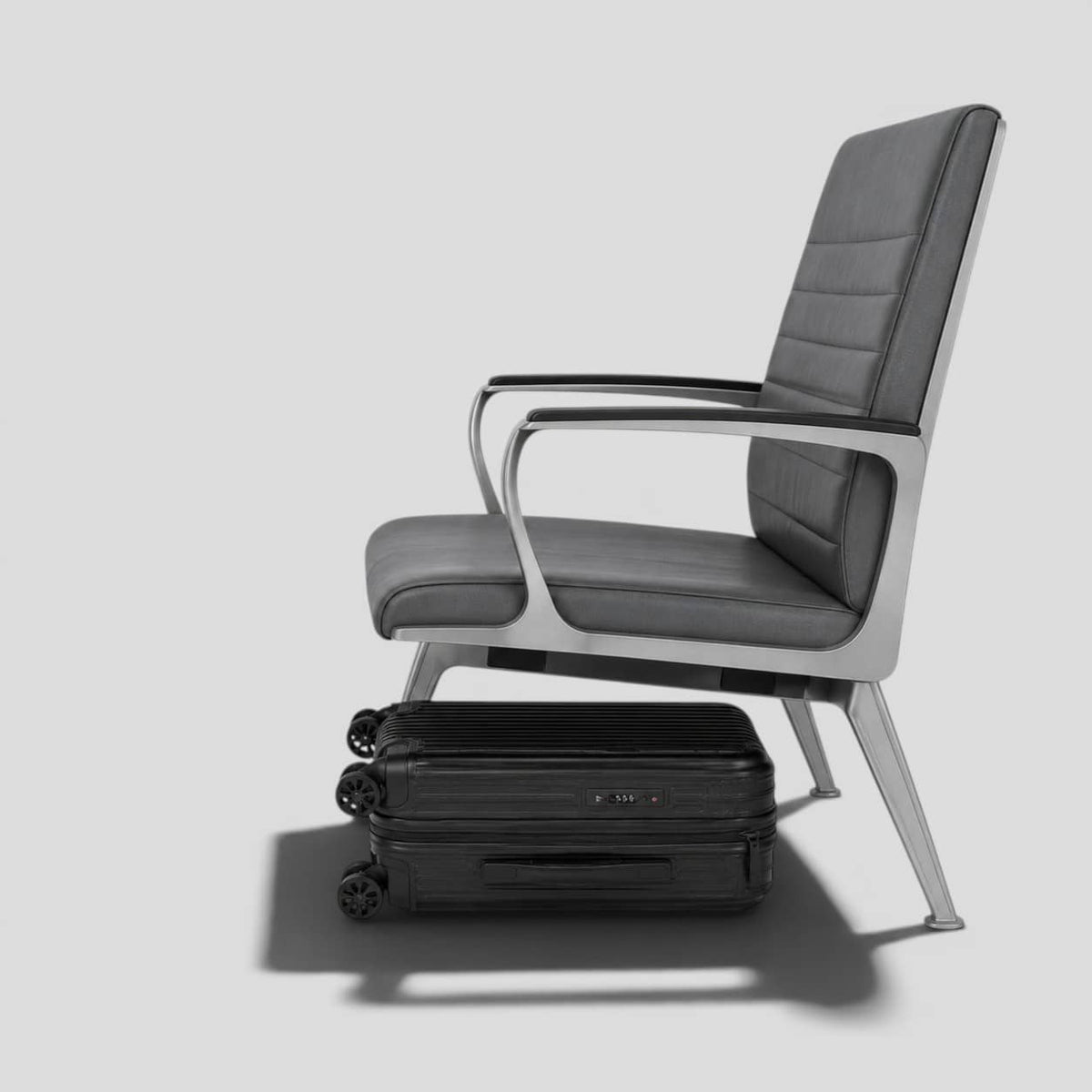 Black onyx hardshell small carry on luggage with extended telescoping handle, ribbed exterior, 360 spinner wheels, and front zip pocket
Underneath chair.