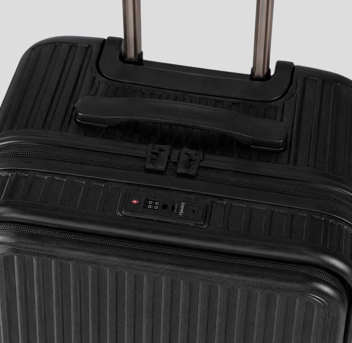 Close-up of TSA combination lock on the front panel of a black onyx small travel carry on hardshell suitcase
