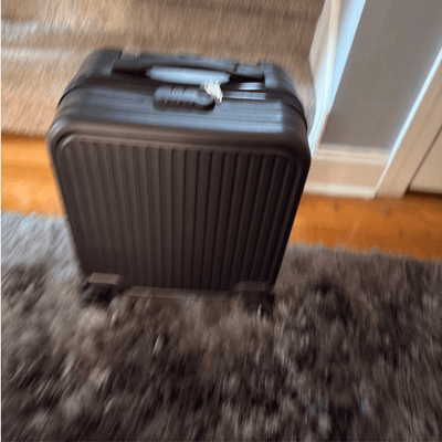 Black suitcase on a carpeted floor