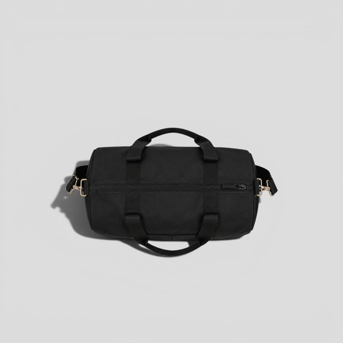 Top-down view of black tactical duffel bag showing dual carry handles, barrel shape, and main zipper compartment