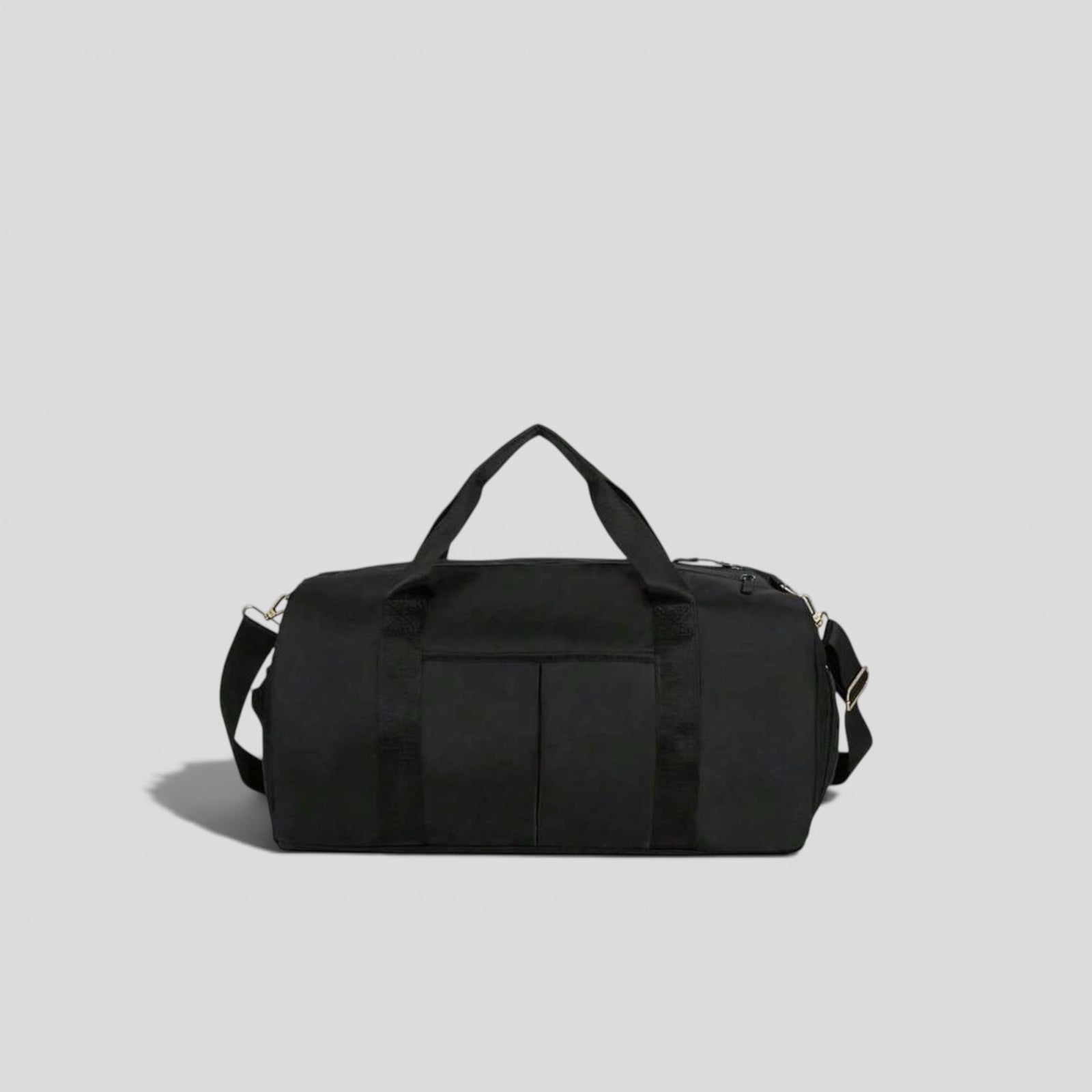 Black canvas tactical duffel bag with top carry handles, front utility pockets, and adjustable shoulder strap with silver hardware