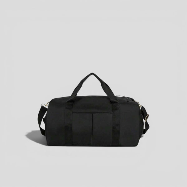 Black canvas tactical duffel bag with top carry handles, front utility pockets, and adjustable shoulder strap with silver hardware