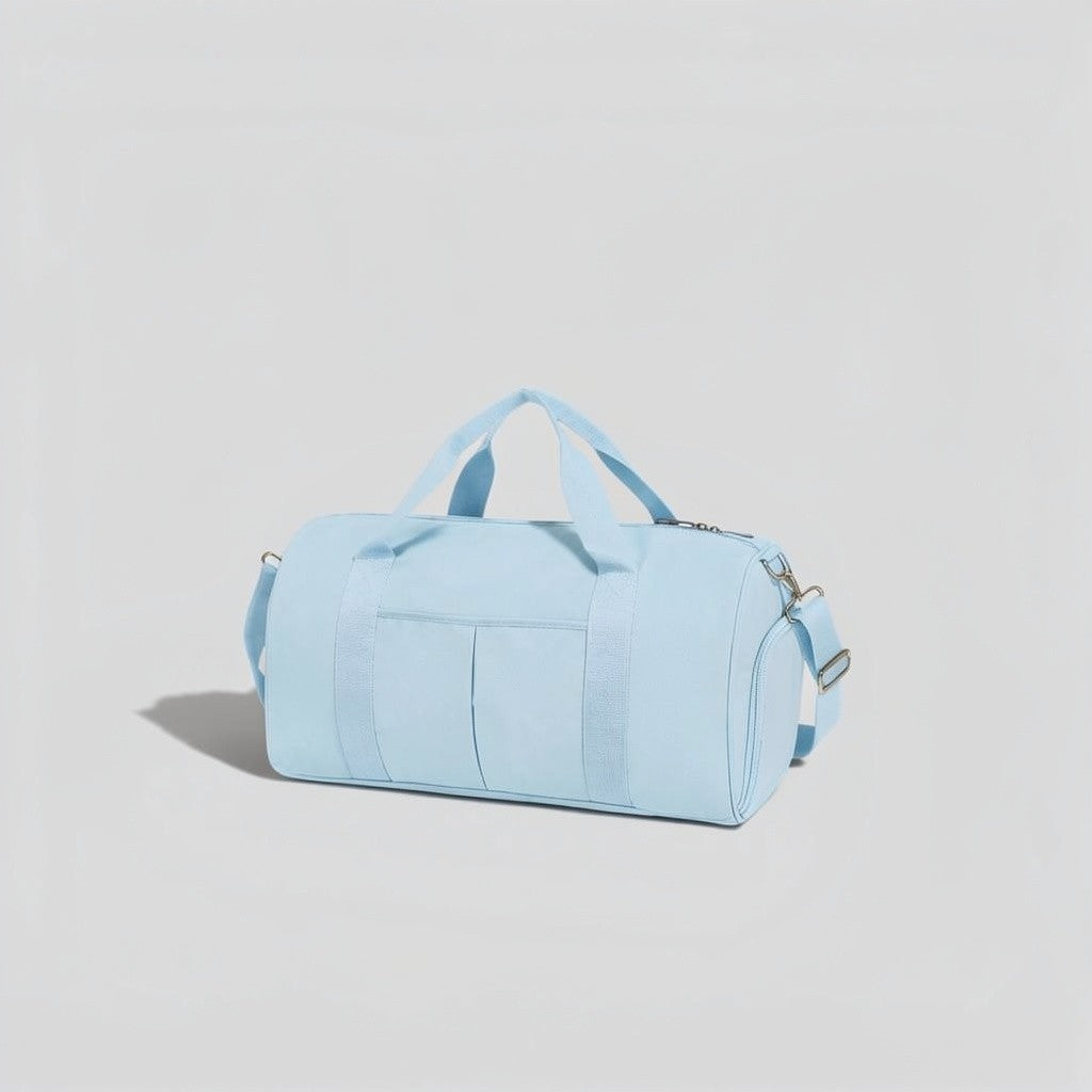 Baby Blue canvas tactical duffel bag with top carry handles, front utility pockets, and adjustable shoulder strap with silver hardware