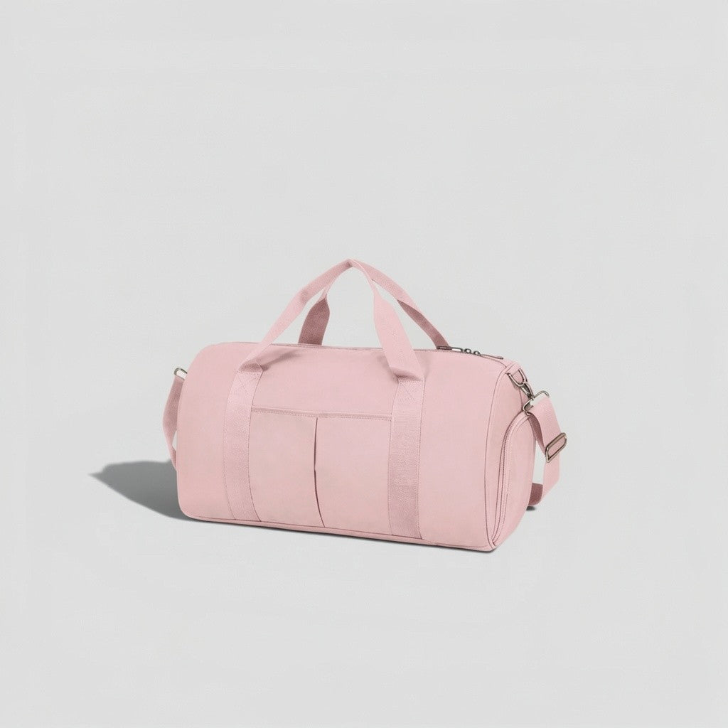 Pink canvas tactical duffel bag with top carry handles, front utility pockets, and adjustable shoulder strap with silver hardware