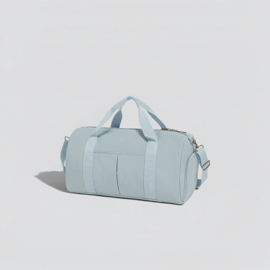 Teal canvas tactical duffel bag with top carry handles, front utility pockets, and adjustable shoulder strap with silver hardware